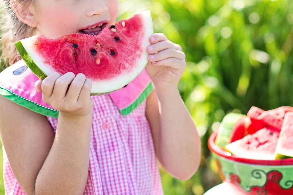 Girl eating healthy watermelon