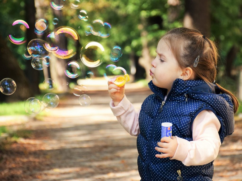 Child blowing bubbles - What is fun?