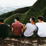 Get By With A Little Help From Our Friends - 4 friends sat looking over a valley