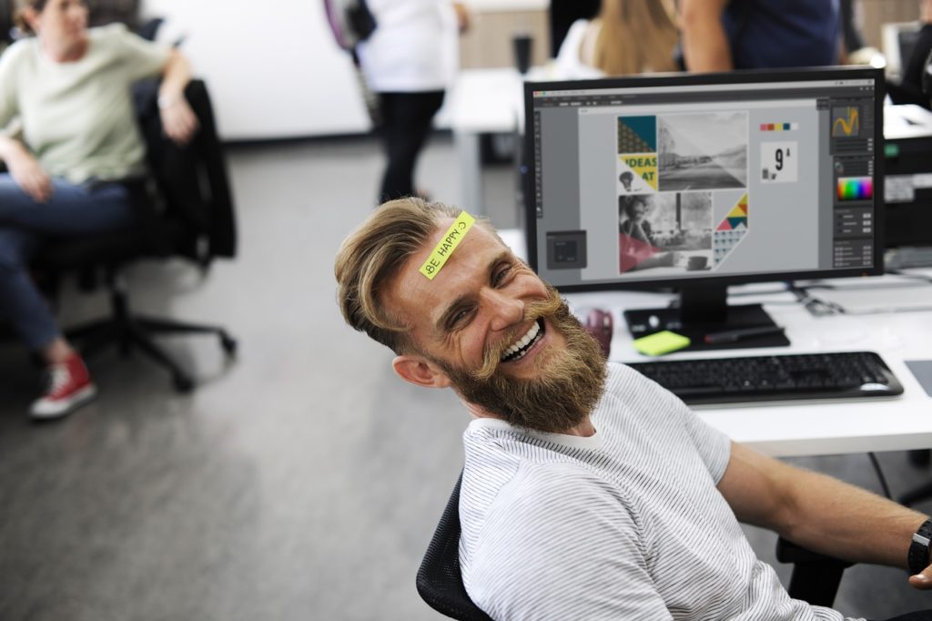 Other ways to nake us happier at work - Man in office laughing