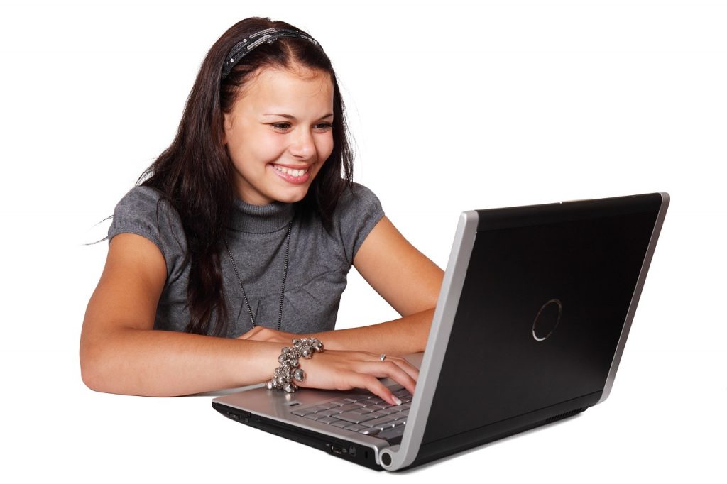 woman sat at laptop smiling