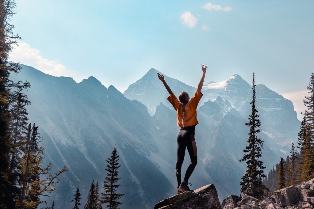 Girl stood in front of mountains full of energy