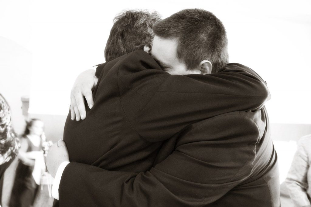 Two men hugging showing why it is important to practice forgiveness