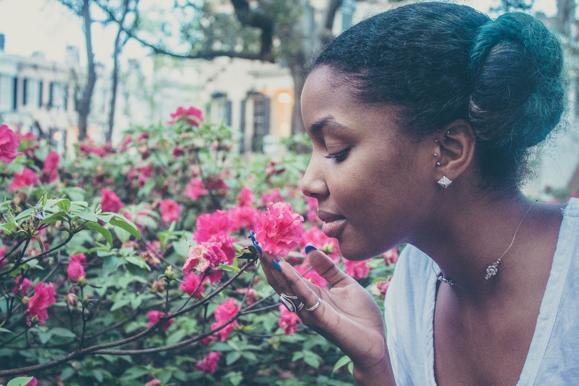 woman smelling flower - how to be happy alone