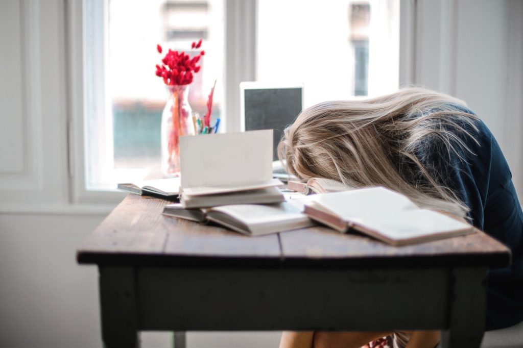 person asleep on a desk - How to tell if your circadian rhythm is disrupted