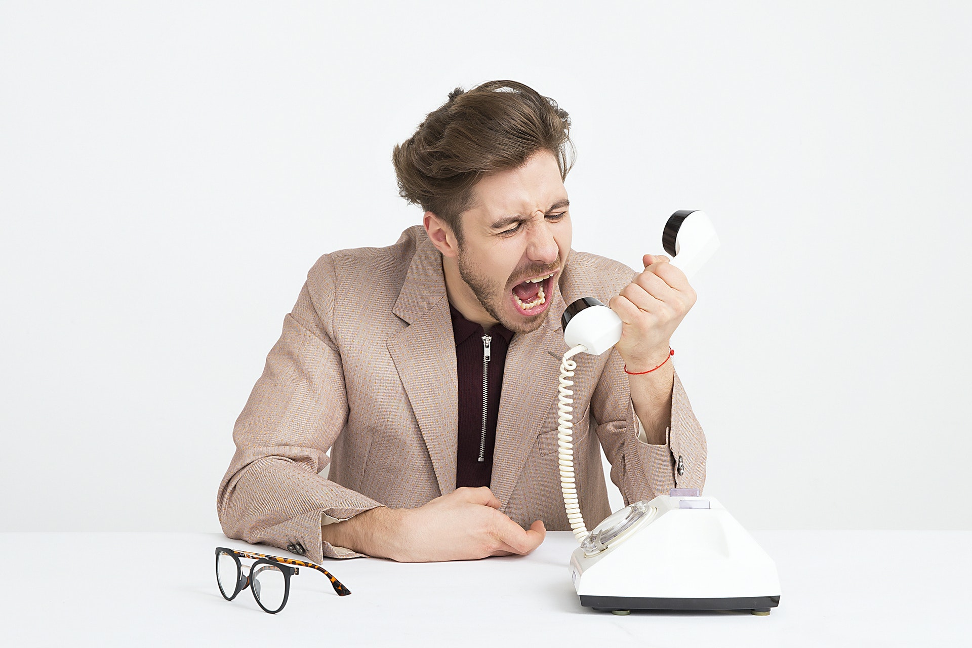 man shouting down the phone - how to handle rude people