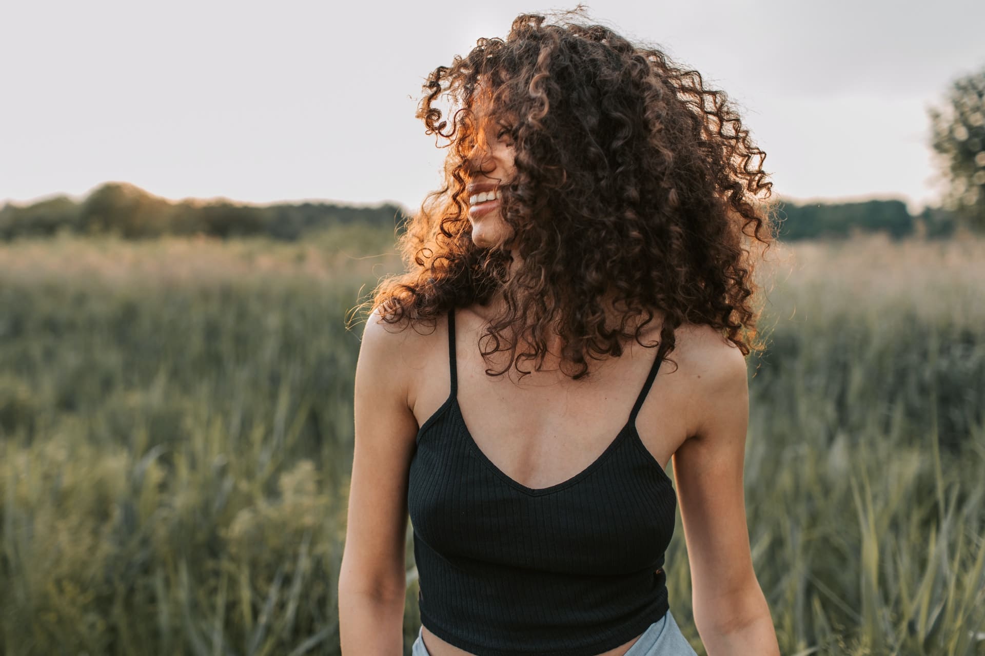 woman smiling and looking happy - how to be happy