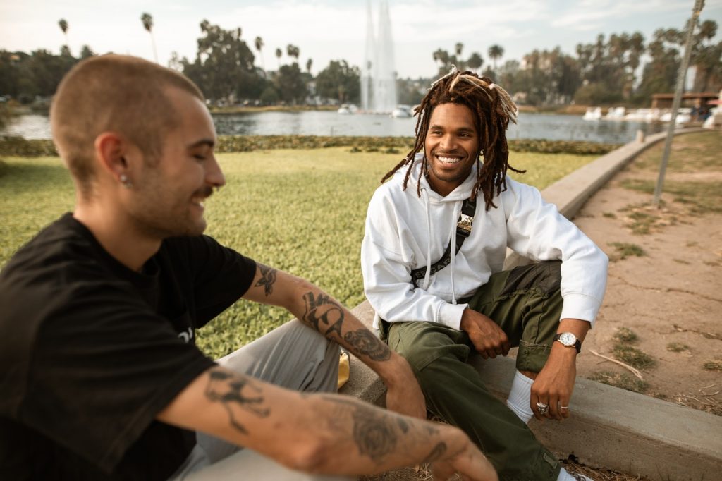 Two men talking and smiling - ways to be happy - connect with others