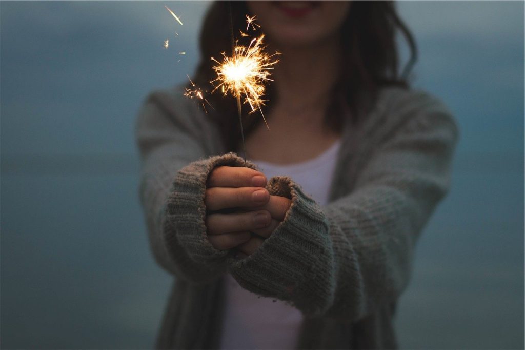 woman holding a sparkler - Enjoy yourself to be happy
