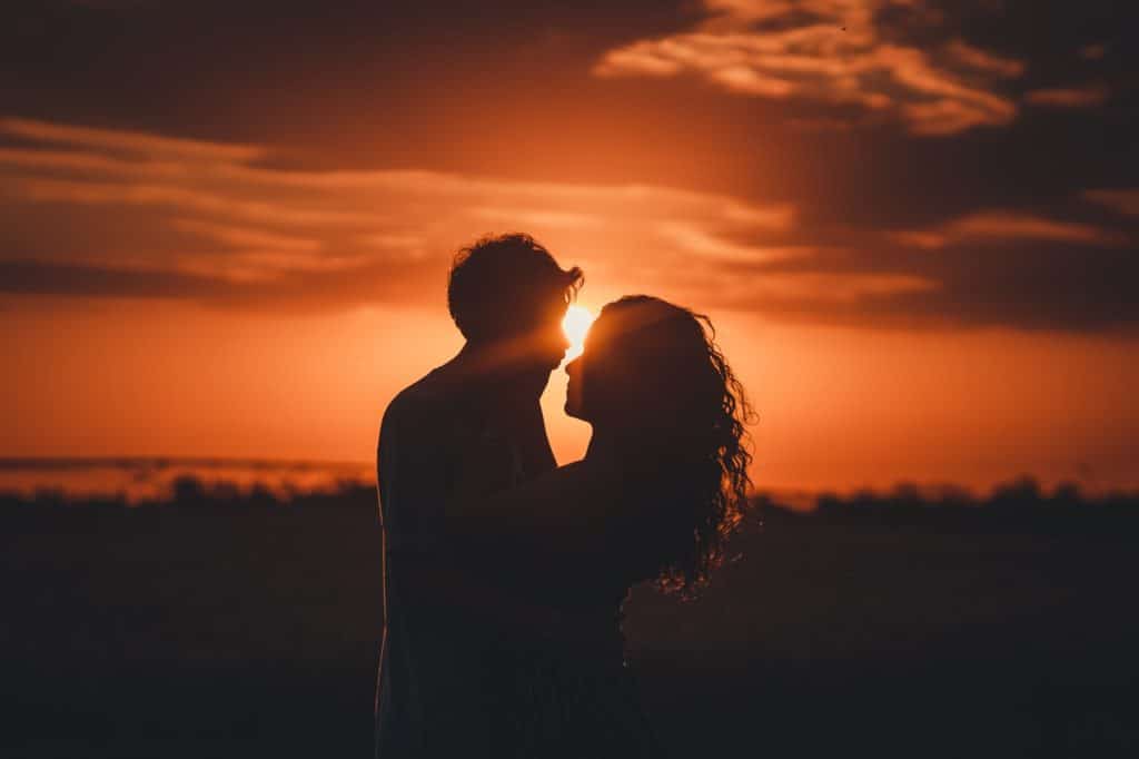Couple kissing in the sunset - Things to do to be romantic