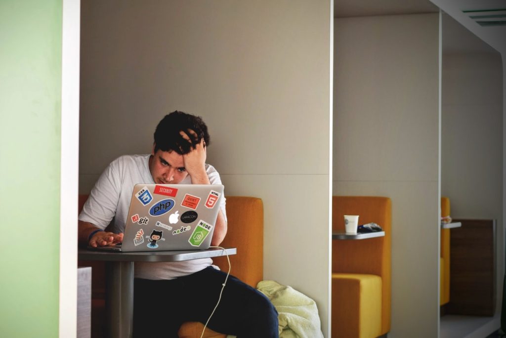 Care less about work - man looking stressed at work