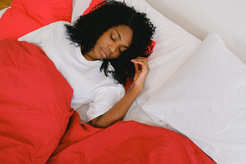 woman taking a nap in bed - Benefits of taking naps - how to get take great naps