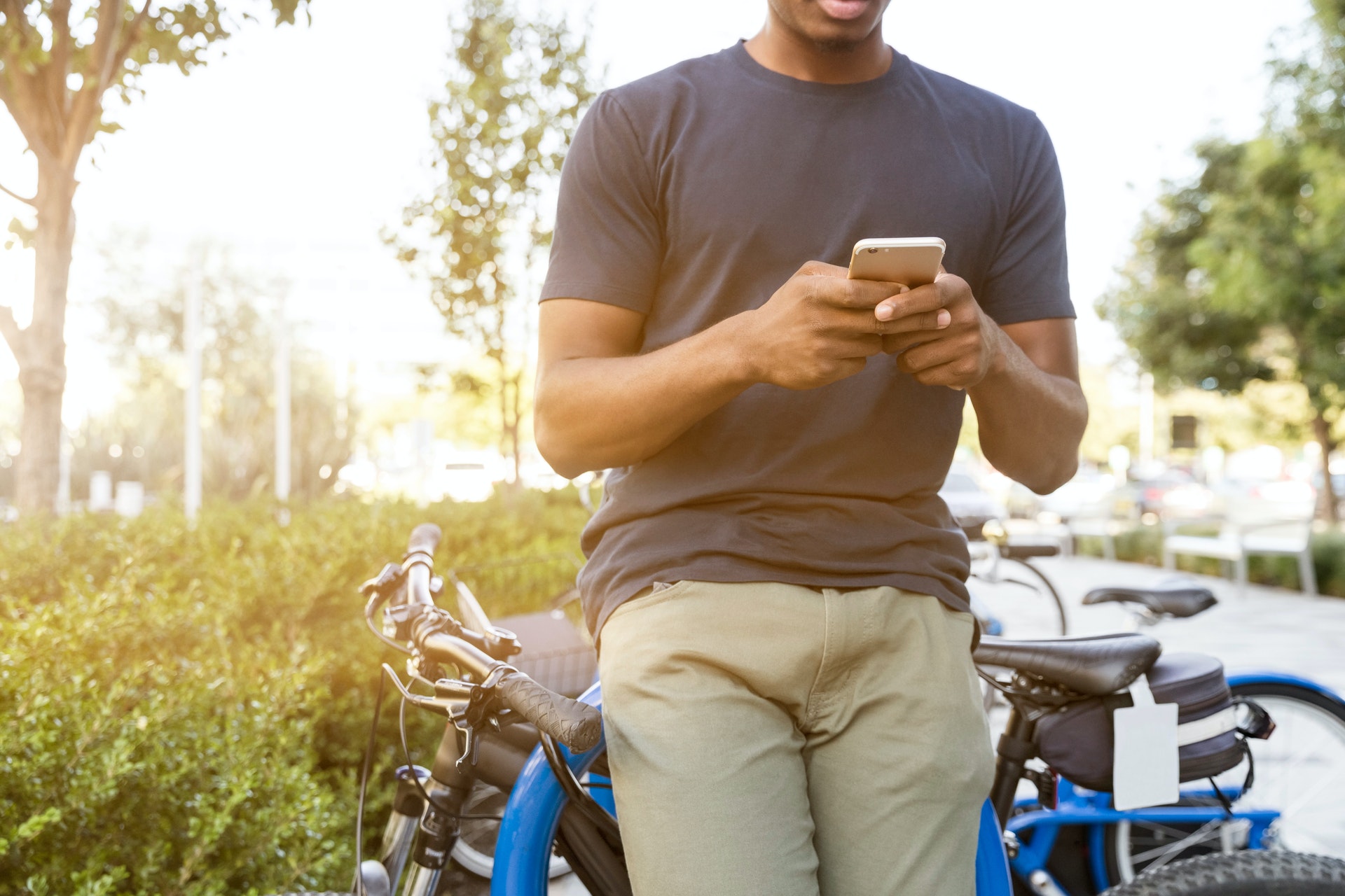 Picture of man looking at phone - Mental health and wellbeing apps