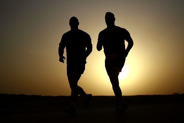 Silhouette of two men running - Quotes about the body - Quotes about exercise