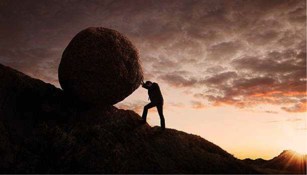Person pushing a boulder up a hill - Why You Should Never Give Up In Life (No Matter What)