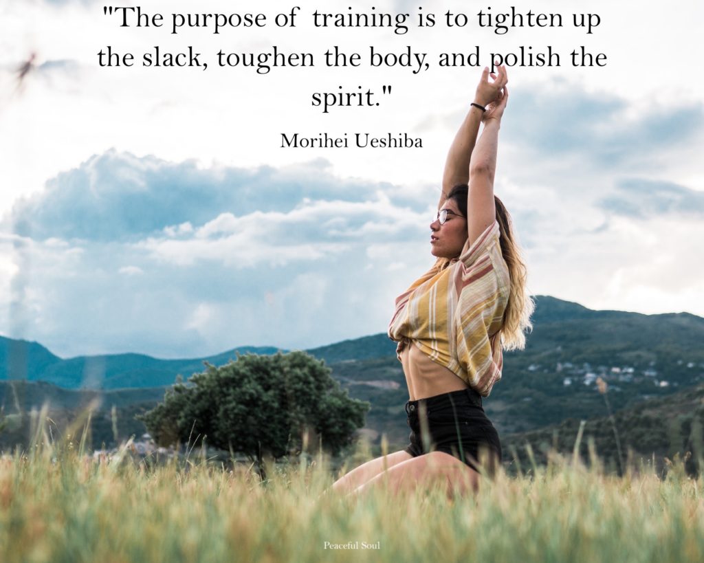 Woman training in a field with mountains in the background - The purpose of training is to tighten up the slack, toughen the body, and polish the spirit. MORIHEI UESHIBA - quotes about exercise