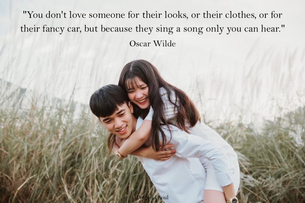 man giving his love  partner a piggy back - You don't love someone for their looks, or their clothes, or for their fancy car, but because they sing a song only you can hear.​ Oscar Wilde - relationship quotes - quotes about love