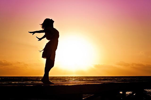 Silhouette of a woman standing in the sun looking free - Love Yourself Quotes - Quotes about love